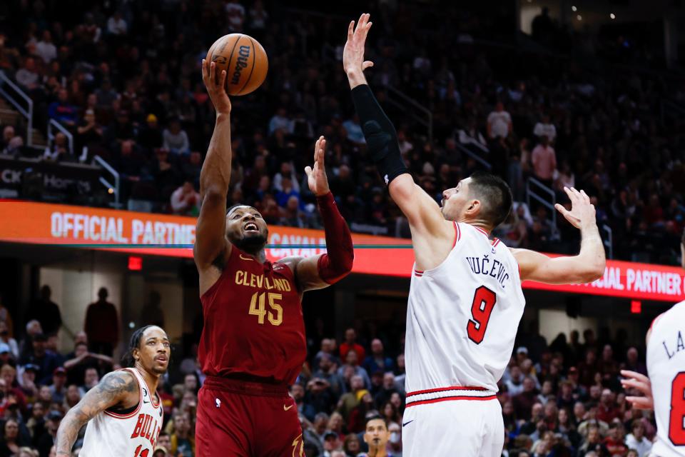 Cleveland Cavaliers guard Donovan Mitchell (45) shoots against Chicago Bulls center Nikola Vucevic (9) during the second half of an NBA basketball game, Monday, Jan. 2, 2023, in Cleveland. (AP Photo/Ron Schwane)