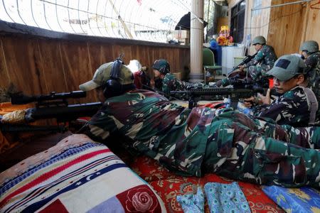 A Filipino sniper lies on a mattress at their combat position in a house as government troops continue their assault against insurgents from the Maute group in Marawi city, Philippines July 1, 2017. REUTERS/Jorge Silva
