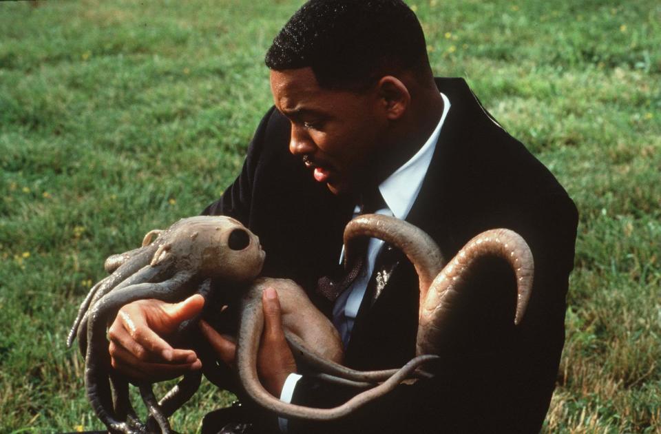 Will Smith holding a baby alien