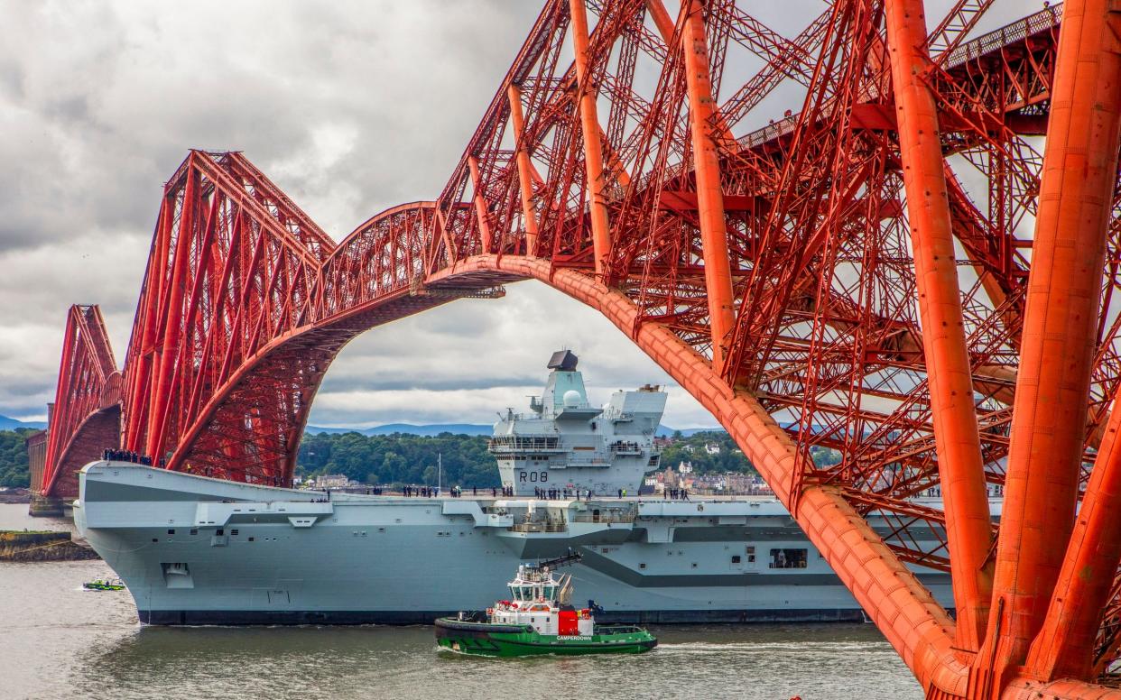 HMS Queen Elizabeth passes under the Forth Bridge