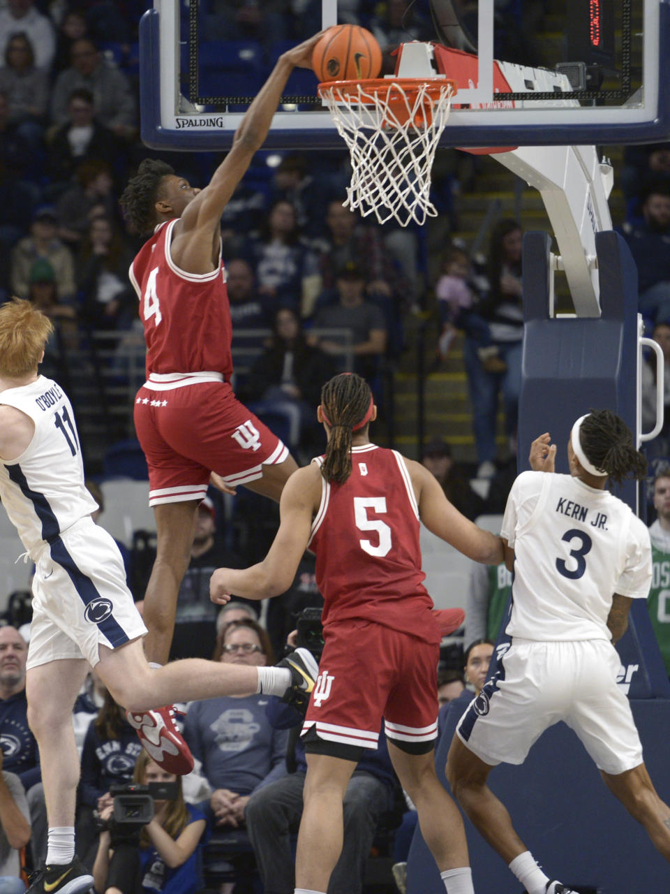 Indiana's Anthony Walker (4) dunks in front of Indiana's Malik Reneau (5) and Penn State's Nick Kern Jr. (3) during the first half of an NCAA college basketball game Saturday Feb. 24, 2024, in State College, Pa. (AP Photo/Gary M. Baranec)