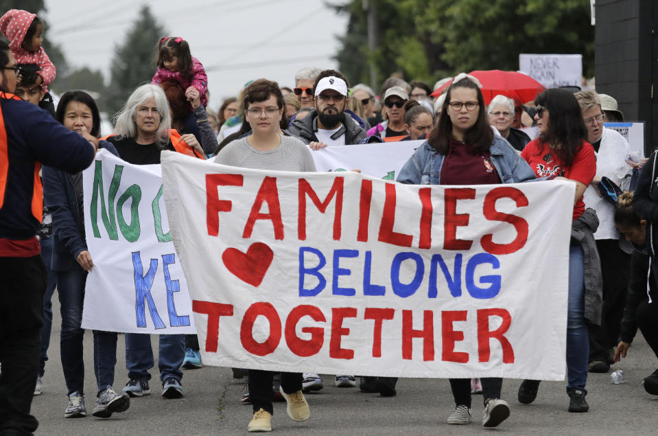 In this photo taken Wednesday, July 17, 2019, Jose Robles, center in white hat, walks with supporters before he presented himself to U.S. Immigration and Customs Enforcement officials in Tukwila, Wash. The prospect of nationwide immigration raids has provided evidence that legions of pastors, rabbis and their congregations stand ready to help vulnerable immigrants with offers of sanctuary and other services. (AP Photo/Elaine Thompson)