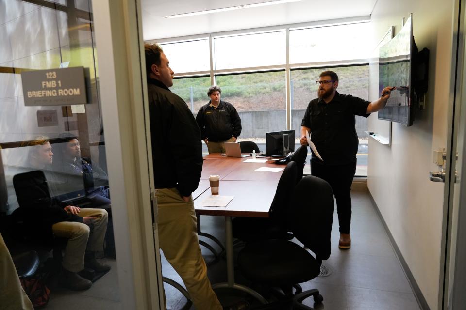 California State University Maritime Academy students listen to a navigation briefing from Assistant Professor Kevin Calnan as they prepare for a simulation of a container ship moving through the Baltimore Harbor with conditions identical to those on March 26, when the cargo ship Dali lost power and struck the Francis Scott Key Bridge.