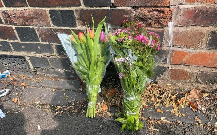 Flowers at the scene of the suspected double murder - STEPHANIE WAREHAM/PA