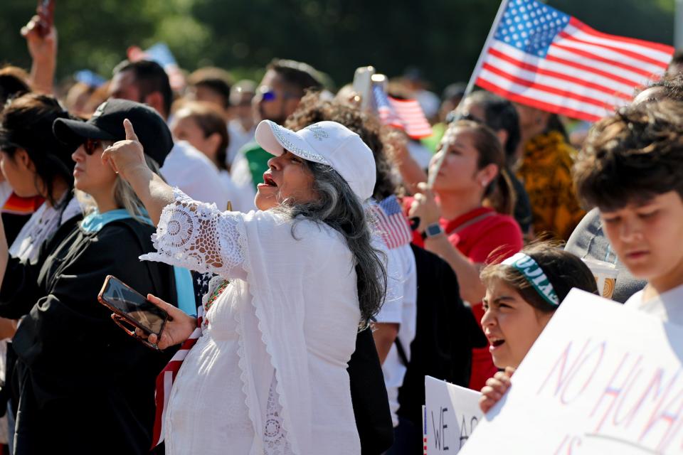 Felisa Hilbert, a retired educator, cheers during a demonstration Wednesday before Hispanic Cultural Day at the state Capitol.