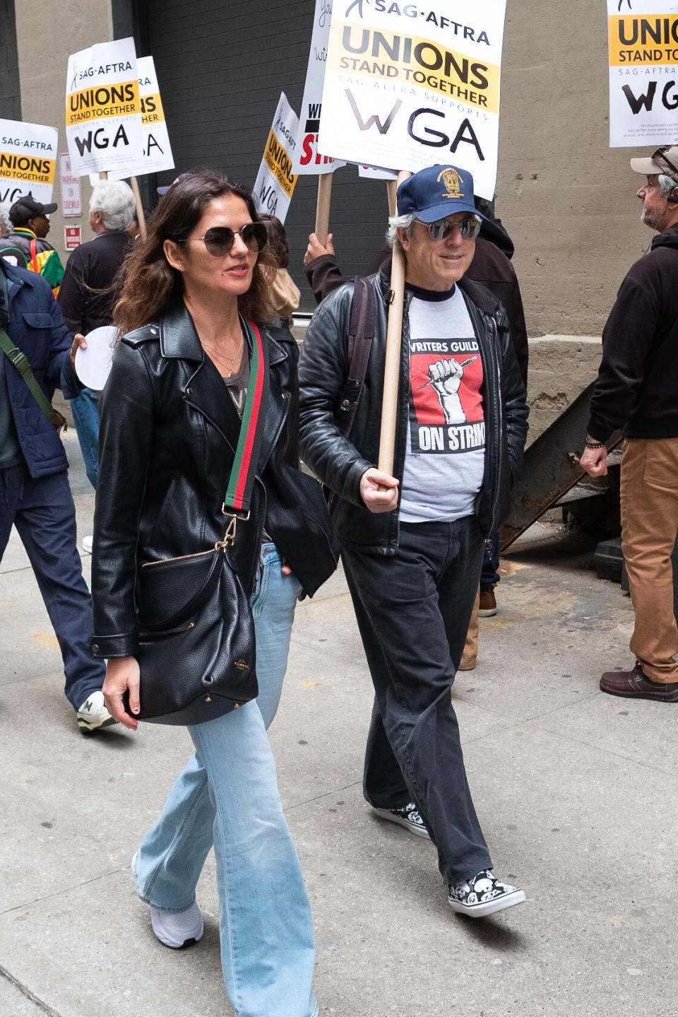 man and woman walk down the street at WGA strike
