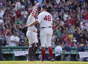 Boston Red Sox relief pitcher John Schreiber (46) is congratulated by Christian Vazquez after closing out the ninth inning of a baseball game against the Tampa Bay Rays at Fenway Park, Monday, July 4, 2022, in Boston. (AP Photo/Mary Schwalm)