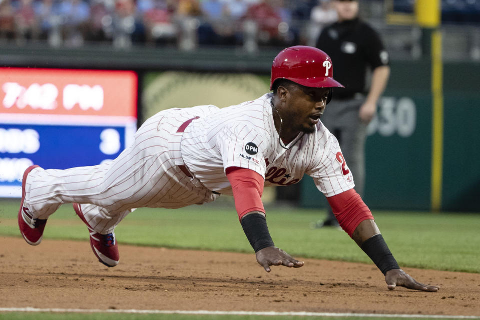 Philadelphia Phillies' Jean Segura dives into third base during the second inning of the team's baseball game against the San Diego Padres on Friday, Aug. 16, 2019, in Philadelphia. (AP Photo/Matt Rourke)