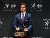 NCAA college football player, LSU quarterback Joe Burrow poses for a photo after winning the Heisman Trophy, Saturday, Dec. 14, 2019, in New York. (AP Photo/Jason Szenes)