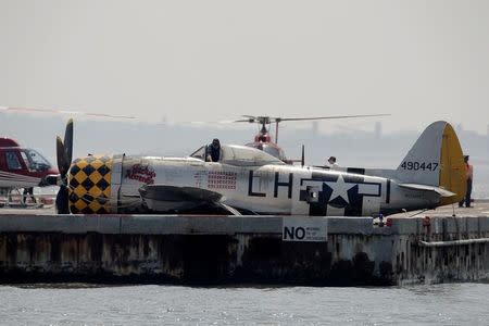 FAA investigators look over the wreckage of a vintage P-47 Thunderbolt airplane that crashed in the Hudson River in New York City, New York, U.S. May 28, 2016. REUTERS/Brendan McDermid