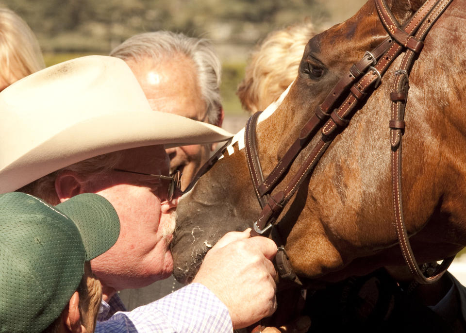 In this image provided by Benoit Photo, co-owner Steve Coburn has a big kiss for his California Chrome following his wire-to-wire for victory in the San Felipe Stakes horse race Saturday, March 8, 2014 at Santa Anita Park in Arcadia, Calif. (AP Photo/Benoit Photo)