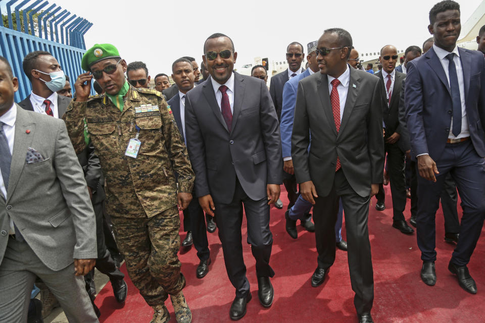 FILE - Ethiopia's Prime Minister Abiy Ahmed, center, arrives for the inauguration ceremony of Somalia's new President Hassan Sheikh Mohamud in Mogadishu, Somalia, June 9, 2022. The al-Shabab extremist group has exploited Ethiopia's internal turmoil to cross the border from neighboring Somalia in unprecedented attacks in July 2022 that a top U.S. military commander has warned could continue. (AP Photo/Farah Abdi Warsameh, File)