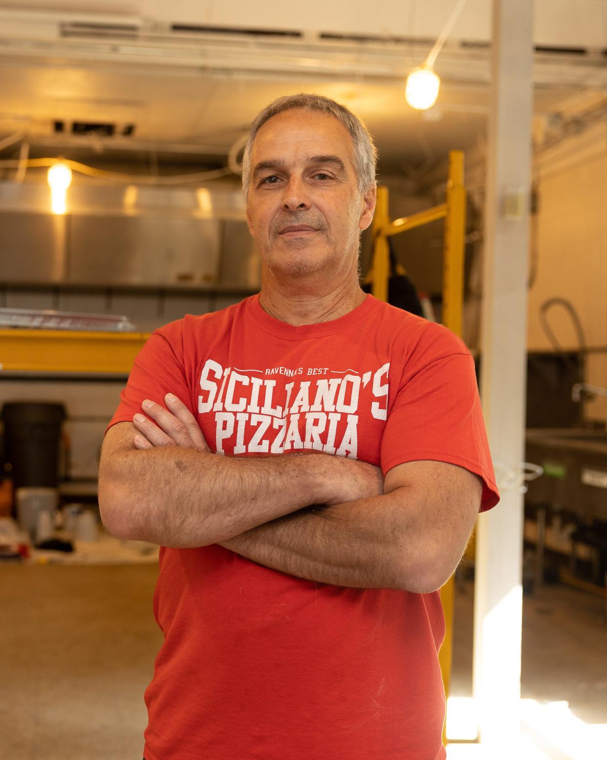 Tom Siciliano, owner of Siciliano’s Pizzaria in Ravenna, stands in the kitchen of his restaurant that sustained a fire back in early July.