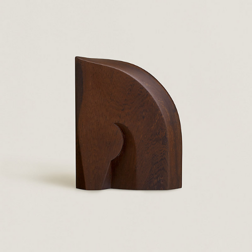 Hermes Alezan dark wood bookend against beige background