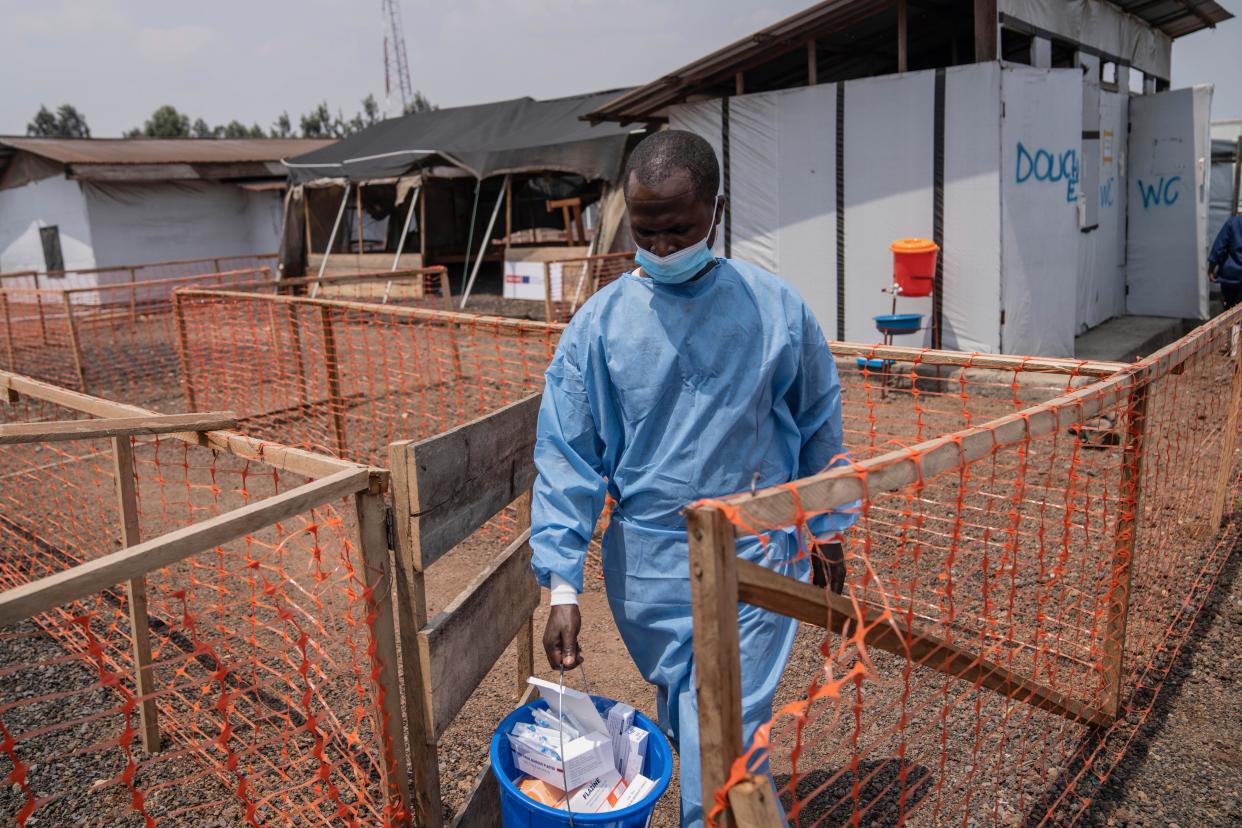 A health worker walks past a mpox treatment centre in Munigi, eastern Congo, Monday, Aug. 19, 2024. Congo will receive the first vaccine doses to address its mpox outbreak next week from the United States, the country's health minister said Monday, days after the World Health Organization declared mpox outbreaks in Africa a global emergency. (AP Photo/Moses Sawasawa)