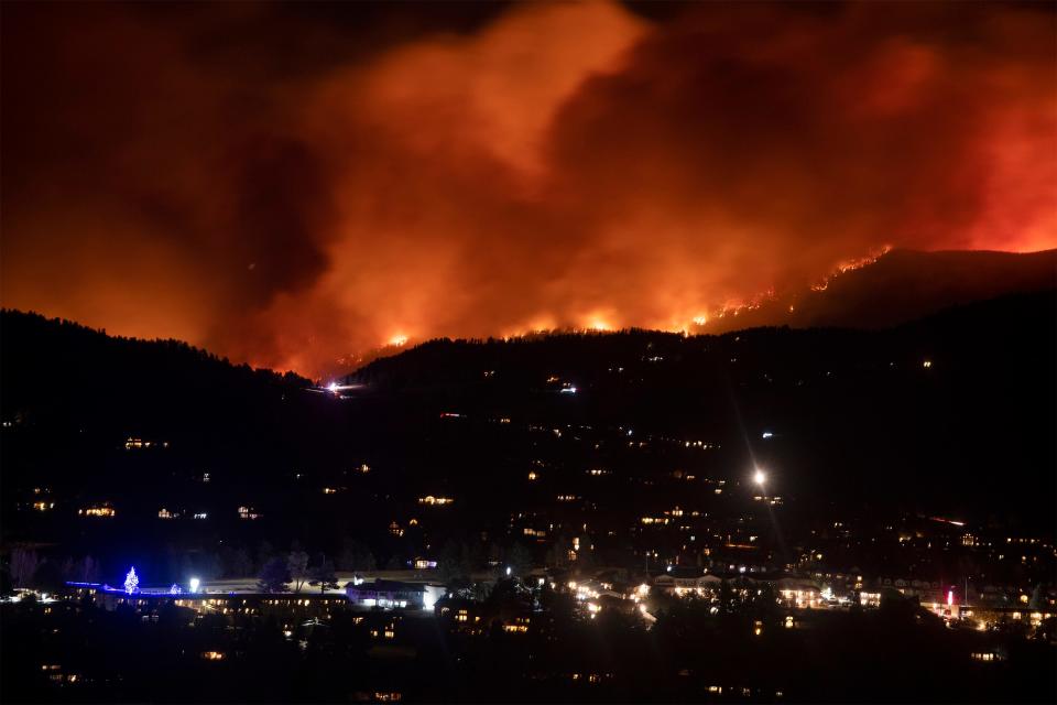 Flames from the Cameron Peak Fire, the largest wildfire in Colorado history, burn trees along a ridge outside Estes Park, Colo., on Oct. 16, 2020.