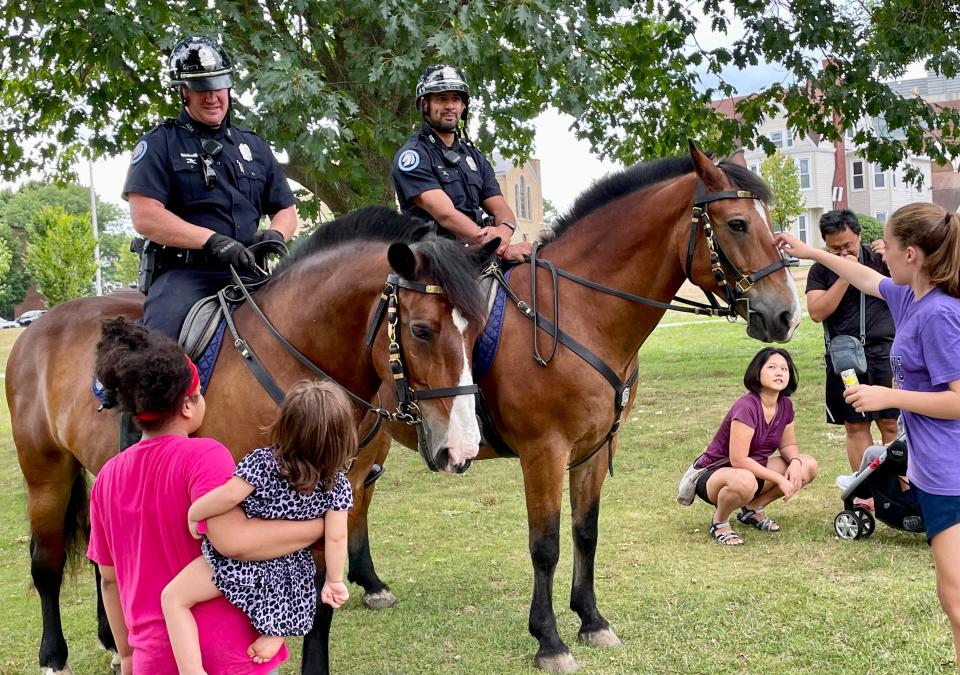 Worcester Police Mounted Unit Officers Joseph Quinn, left, and Jose Rodriguez, introduce their equine partners Buster and Major, to kids and families during Saturday's Back-to-School Bash and Community Party at Institute Park.