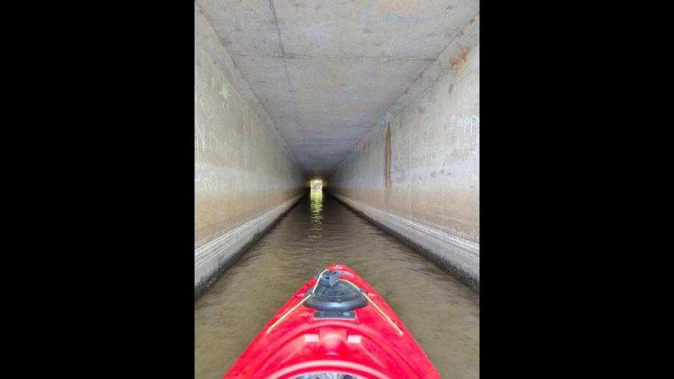 Wyatt Maxey kayaks through the tunnel-like culvert under Interstate 77 that connects Lake Cornelius with Lake Norman. WYATT MAXEY/WYATT MAXEY