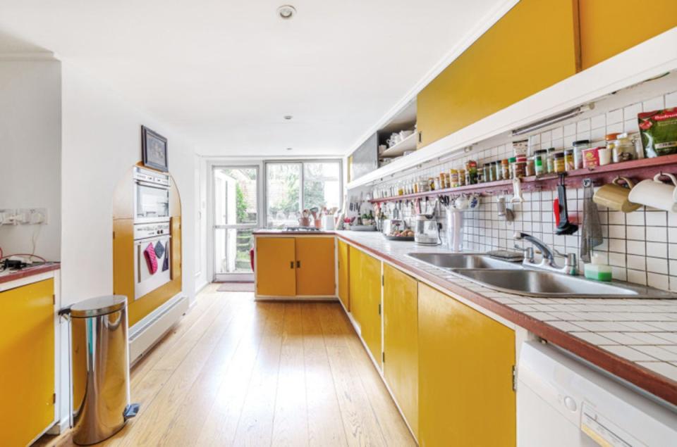 The Fifties kitchen, with its mustard yellow cabinetry (Benham & Reeves)