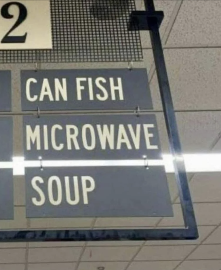 Store sign with items listed: "CAN FISH," "MICROWAVE," and "SOUP" in separate lines