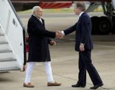 Prime Minister Narendra Modi is greeted by Britain's Minister of State for the Foreign and Commonwealth Office, Hugo Swire after arriving at Heathrow Airport for a three day official visit, in London, November 12, 2015. REUTERS/Jonathan Brady/Pool