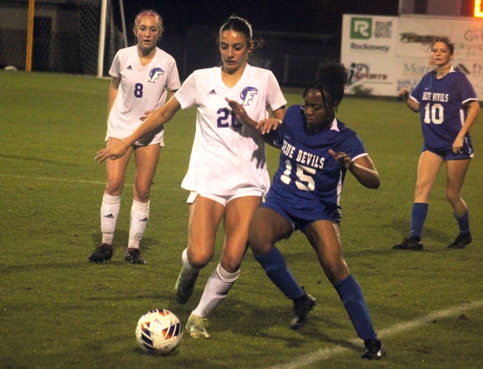 Fletcher defender Anadora Wassouf (20) and Stanton forward Courtney Brown (15) challenge for possession along the sideline.