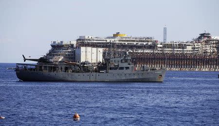 A military vessel patrols around the cruise liner Costa Concordia during the refloat operation maneuvers at Giglio Island July 23, 2014. REUTERS/ Max Rossi