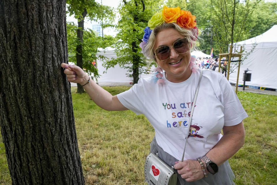 Agata Misiorna knocks on the wood of a tree trunk, saying she hopes for positive change for transgender youth, ahead of the yearly Pride parade in Warsaw, Poland, on Saturday June 17, 2023. Parents of trans children are mobilizing in Poland seeking acceptance after the country’s leader mocked trans people last year during Pride season. Poland has been ranked as the worst country in the European Union for LGBTQ+ rights. (AP Photo/Czarek Sokolowski)