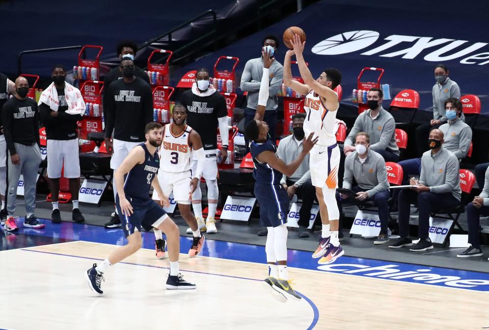 Feb 1, 2021; Dallas, Texas, USA; Phoenix Suns guard Devin Booker (1) hits the game-winning shot during the fourth quarter against the Dallas Mavericks at American Airlines Center. Mandatory Credit: Kevin Jairaj-USA TODAY Sports