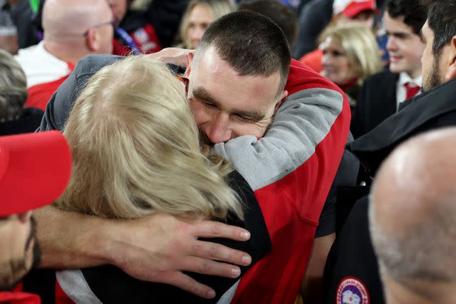 <p>Patrick Smith/Getty</p> Travis Kelce hugs his mom, Donna Kelce, after winning the AFC Championship Game on Jan. 28, 2024.