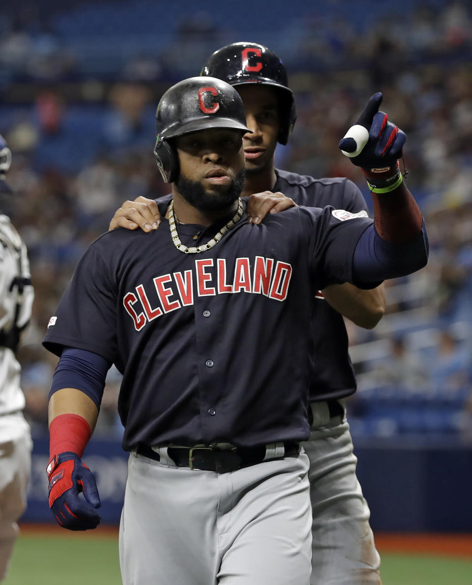 Cleveland Indians' Carlos Santana, front, celebrates with Oscar Mercado after Santana hit a two-run home run off Tampa Bay Rays' Diego Castillo during the first inning of a baseball game Saturday, Aug. 31, 2019, in St. Petersburg, Fla. (AP Photo/Chris O'Meara)