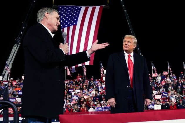 Sen. David Perdue (R-Ga.) speaks as President Donald Trump looks on at a campaign rally at Valdosta Regional Airport in December 2020. Perdue is building his 2022 gubernatorial campaign around Trump and veering to the right as he tries to unseat Republican Gov. Brian Kemp in the primary. (Photo: AP Photo/Evan Vucci, File)