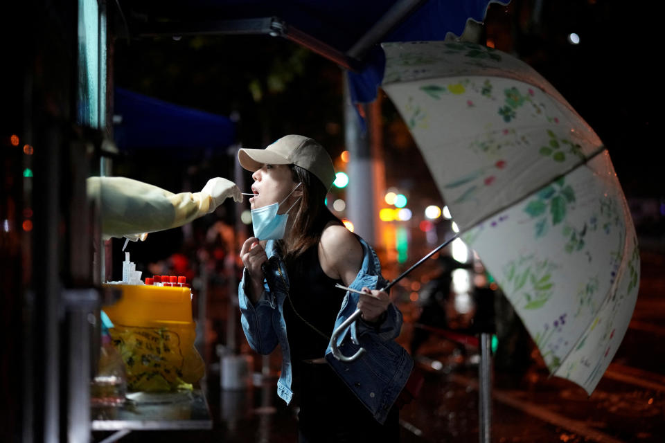 A woman gets tested for the coronavirus disease (COVID-19) at a nucleic acid testing site as Typhoon Muifa approaches, following the coronavirus disease (COVID-19) outbreak, in Shanghai, China, September 14, 2022. REUTERS/Aly Song