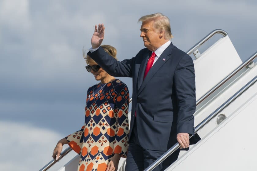 Former President Donald Trump and Melania Trump disembark from their final flight on Air Force One at Palm Beach International Airport in West Palm Beach, Fla., Wednesday, Jan. 20, 2021. (AP Photo/Manuel Balce Ceneta)