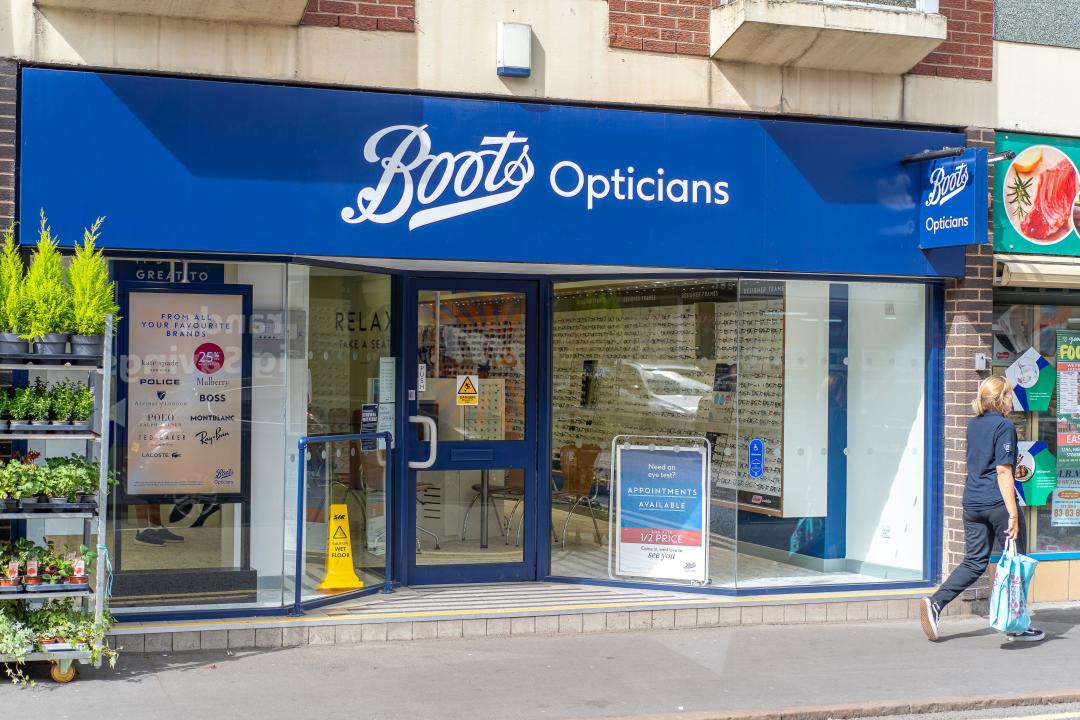 Front entrance view of a Boots Opticians shop on a high street,