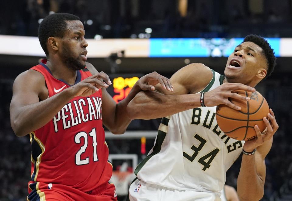 Milwaukee Bucks' Giannis Antetokounmpo is fouled by New Orleans Pelicans' Darius Miller during the second half of an NBA basketball game Wednesday, Dec. 19, 2018, in Milwaukee. The Bucks won 123-115. (AP Photo/Morry Gash)