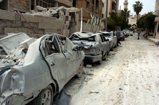 A picture released by the official Syrian Arab News Agency (SANA) shows vehicles that were damaged following blasts in the city of Idlib, northwest Syria. Twin blasts targeting security buildings killed more than 20 people in the northwest Syrian city of Idlib, a monitoring group said, as the chief UN monitor presses both sides to end more than 13 months of violence