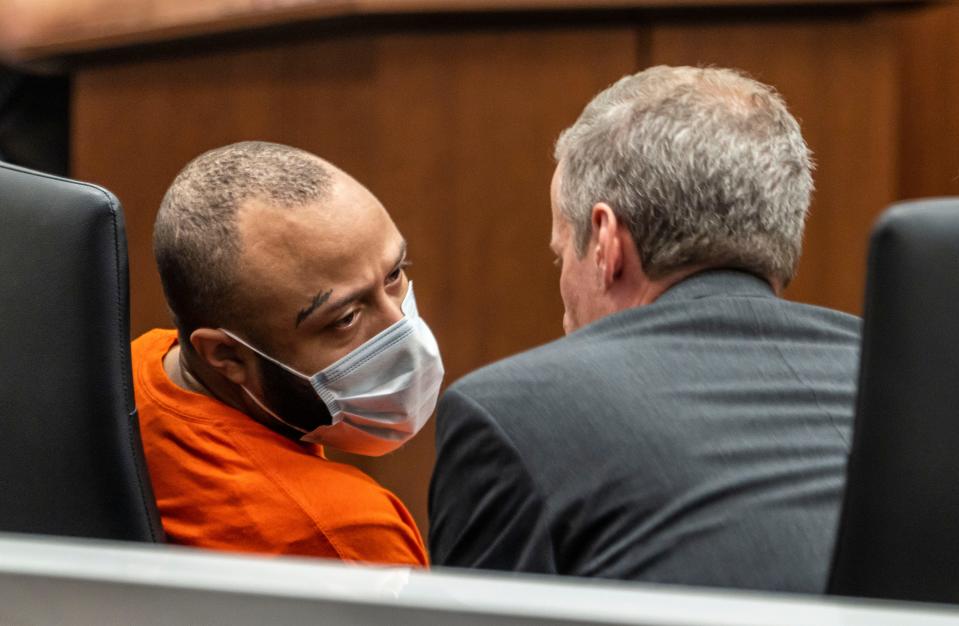 Darrell Brooks Jr., left, speaks with his attorney Jeremy Perri, during a jury status hearing on Friday in Waukesha County Court in Waukesha. Brooks is charged with killing six people and injuring more than 60, accused of driving his SUV through the Waukesha Christmas parade in November 2021.