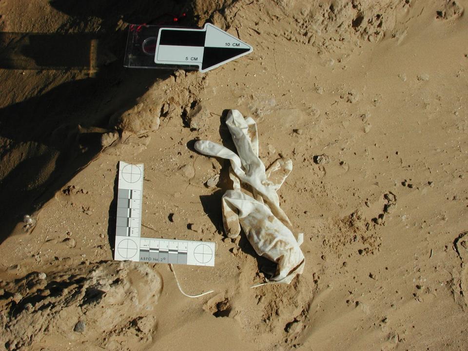 Medical gloves are measured at a mass grave in Dasht-e-Leili, Afghanistan, in 2002. <a href="https://www.flickr.com/photos/physiciansforhumanrights/albums/72157621178761239/with/3370825172/" rel="nofollow noopener" target="_blank" data-ylk="slk:Stefan Schmitt/Physicians for Human Rights;elm:context_link;itc:0;sec:content-canvas" class="link ">Stefan Schmitt/Physicians for Human Rights</a>