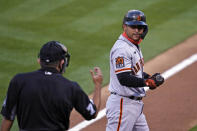 San Francisco Giants' Donovan Solano, right, looks at home plate umpire Alfonso Marquez and walks back to the dugout after striking out swinging against Oakland Athletics starting pitcher Chris Bassitt in the first inning of a baseball game Friday, Sept. 18, 2020, in Oakland, Calif. (AP Photo/Eric Risberg)