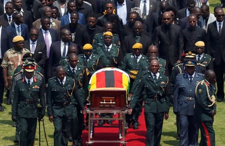 Mugabe is brought to the national sports stadium for a state funeral in Harare