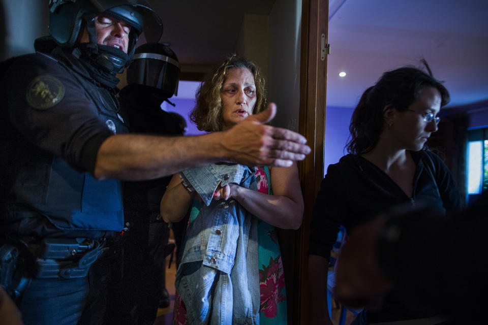 <p>Carmen Rives, 50, gestures as riot police enter her apartment to evict her, Madrid, June 2, 2015. (AP Photo/Andres Kudacki) </p>