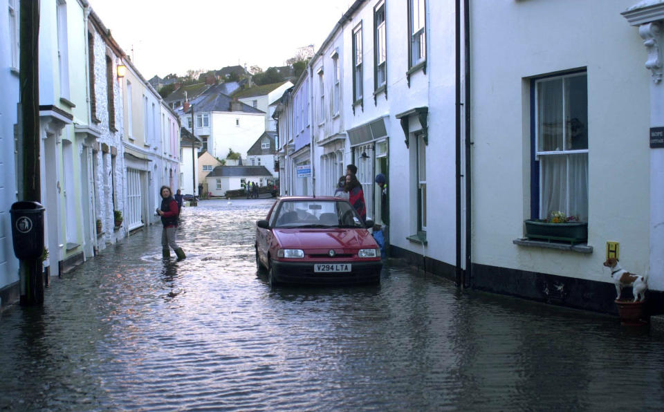 Residents walk through the flooded village of Flushing, Cornwall, south western England March 10, 2008. A storm rushing in from the Atlantic lashed the south west on Monday as high winds and tides brought the risk of coastal flooding.      REUTERS/Paul Armiger   (BRITAIN)