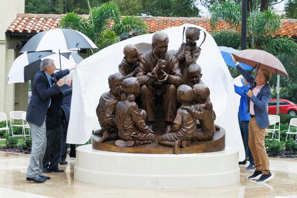 Rollins College officials unveil a sculpture honoring alumnus and beloved children’s TV host Mister Rogers in 2021 in Winter Park, Fla.