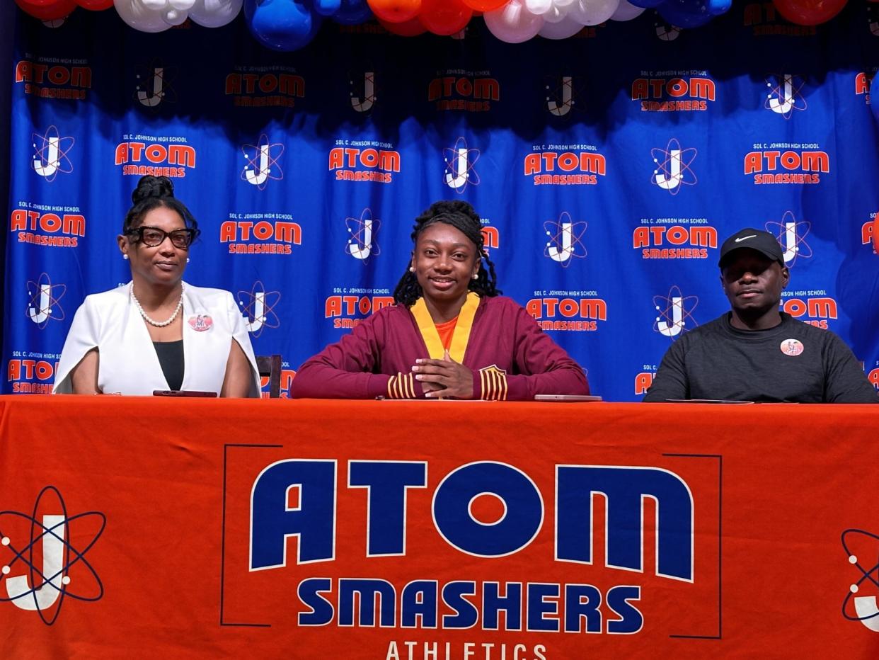 Haely Grant of Johnson, pictured with her parents, signed with the Bethune-Cookman track and field program on Monday, April 15.