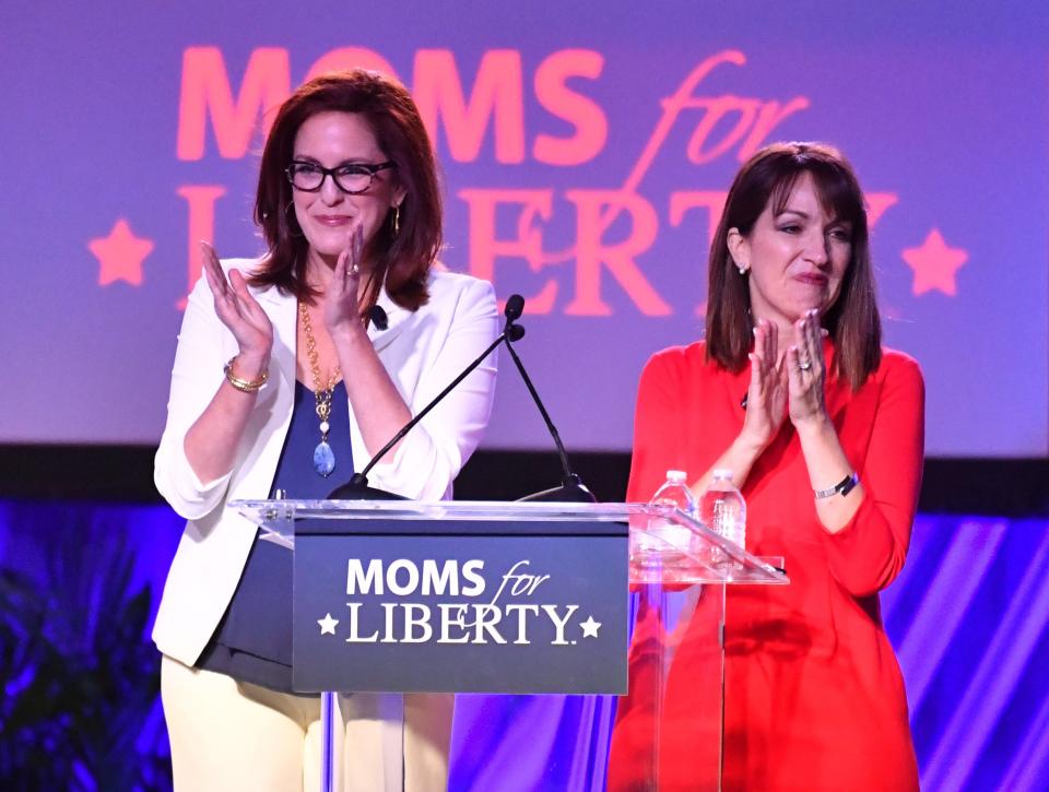 Moms for Liberty co-founders Tiffany Justice, left, and Tina Descovich greet attendees as they open the first Moms for Liberty National Summit on July 15, 2022 in Tampa, Florida. The convention continued through July 17 with conservative speakers and strategy sessions for members.