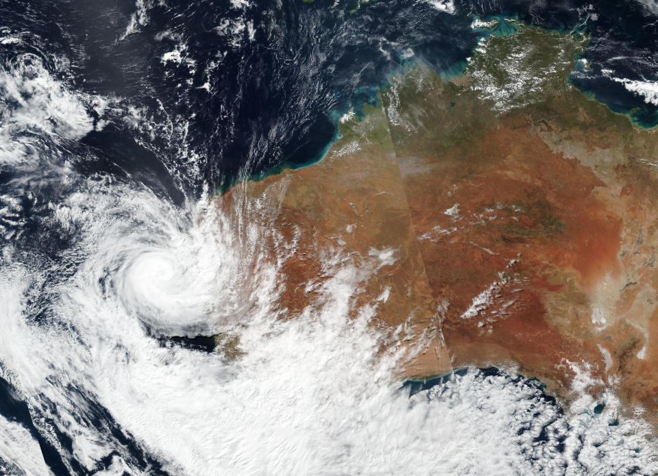 This Sunday, April, 11, 2021, satellite image released by NASA shows Tropical Cyclone Seroja hitting the coast of Western Australia. People living on the coast were preparing themselves Sunday for the landfall of Seroja. (NASA Worldview, Earth Observing System Data and Information System (EOSDIS) via AP)