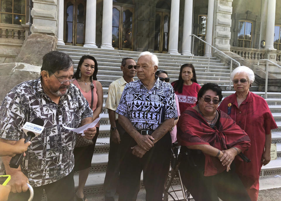 Jan Dill, a board member of a foundation a 92-year-old Hawaiian heiress established for Native Hawaiians, reads a statement to the media as other board members and supporters look on in Honolulu on Thursday, Sept. 6, 2018. The foundation's board members want Abigail Kawananakoa's wealth to be used to help Native Hawaiians. Kawananakoa is embroiled in a legal fight for control over her $215 million trust. (AP Photo/Jennifer Sinco Kelleher)