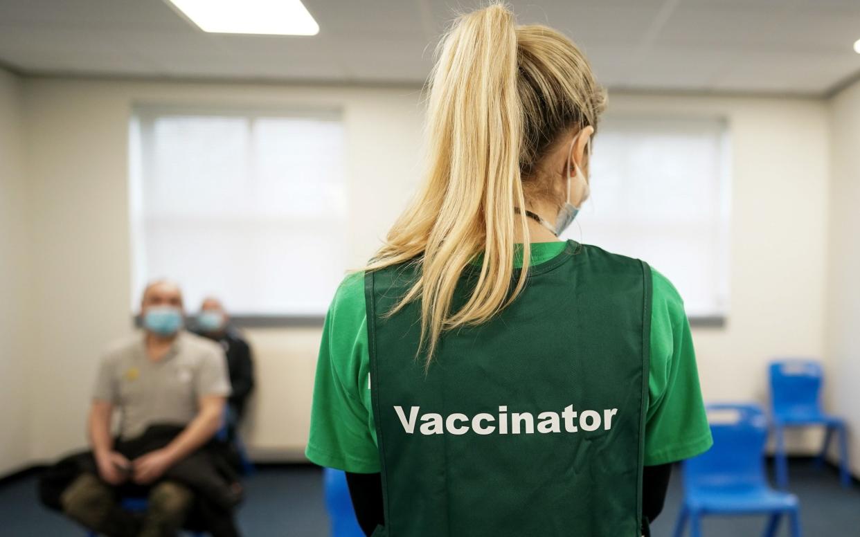 A vaccinator at the Arnison Vaccination Centre, near Durham, waits to assist patients - Ian Forsyth/Getty