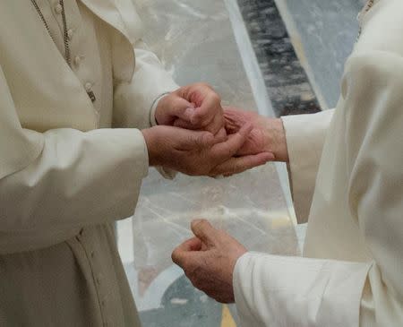 Former pope Benedict (R) is greeted by Pope Francis during a ceremony to mark his 65th anniversary of ordination to the priesthood at the Vatican June 28, 2016. Osservatore Romano/Handout via Reuters